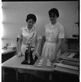 Students working with a scale in a Home Economics research lab, February 1964