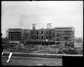 Failing School, Portland, under construction. Full front view of building, with scaffolding erected. Construction debris in foreground.