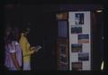 Laurie Gay and Sheila Jones observing Oregon State University kiosk at Oregon State Fair, Salem, Oregon, circa 1973