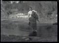 Irene Finley carrying William Jr. across a creek