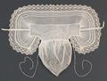 Baby Cap of fine white net with large flap of stiffened net with pin pleats and floral bobbin lace trim