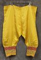 Pants "Salwar" of yellow sateen with wide cuffs at hem of dark yellow and red sateen embellished with raised metallic cord tinsel embroidery