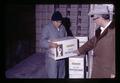 Person loading Encore french fries into truck and Julius Binder, Metolius, Oregon, February 1972