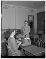 Dr. Fred Winger and a student demonstrate typing techniques using a tachistoscope