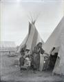 Woman with children at entrance to tepee