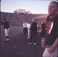 Head coach Tommy Prothro with his players and assistants on the OSU sideline, 1965 Rose Bowl football game