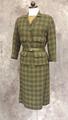 Skirt suit ensemble of dark olive green wool plaid paired with a silk blouse