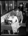 Ruth Baughman of Yuba City, California, beginning to complete the hem on a coat she is making, July 9, 1951