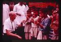 Jim Howard with kids eating chapatis, India, 1979