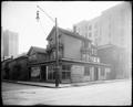 Houses on site of Telephone Building, Oak and S. E. Park, Portland. Bushong Co. furniture showroom in foreground. Power pole on corner.