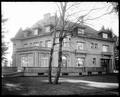 Rear view of Pittock Mansion, Portland, showing round towers. Bare tree in foreground.