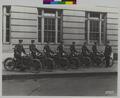 7 Portland policemen, on Harley-Davidson motorcycles. One officer standing next to them (recto)