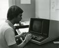 Unidentified individual using an early model desktop computer, 1970s