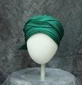 Turban-style hat of stiffened green, woven fabric with soft pleats at the crown and folds and wraps around the sides