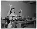 Home Economics student working in a nutrition laboratory, June 1957