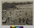 Crowd of people at rocky shore (recto)