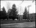 Campus of University of Oregon, with Friendly Hall in background. 13th St. in foreground.