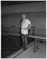 Gerhard Flood demonstrating floating fishing boots, July 1958