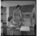 Home Economics students working to upholster a chair, February 1964