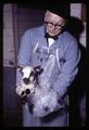 Paul Weswig holding lamb in plastic bag, Oregon State University, Corvallis, Oregon, circa 1970