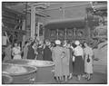 Home Economics students examining an industrial textiles machine on a field trip, April 1952