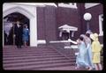 Women trying to catch bridal bouquet on front steps of First United Methodist Church at Suwat-Wolfe wedding, Corvallis, Oregon, 1966