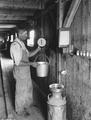 Roy Vanderwall weighing milk on his farm in the Muddy Creek community in Baker County, Oregon