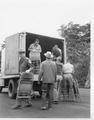 Forest Service personnel unloading chairs from truck