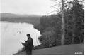 Man studying document at Lakeside. Appears to be opposite shore from photo 02-152
