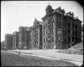 St. Vincent's Hospital, Portland. Ambulance, other autos at 25th St. entrance. Street in foreground.