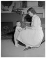 A Home Economics student and "practice baby" in the Kent House, May 1958