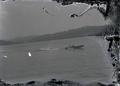Speedboat pulling rafter on lake?