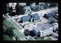 Aerial view of gathering at Corvallis Art Center and adjacent funeral home, Corvallis, Oregon, 1976