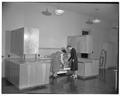 Home Economics students loading a dishwasher in Milam Hall, January 1954