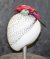 Hat of a corsage over wide black bet