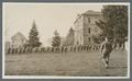 Cadets walking line abreast below Benton Hall, circa 1920