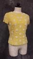 Blouse of yellow linen embellished with white beads