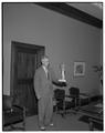 President Strand holding a model of the Lady of the Fountain statue