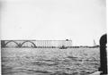 Constructing the Alsea Bay bridge about 1935.  View looks from east to west as construction was started from the south end of the bridge.