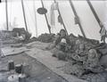 Woman and children sitting inside tepee