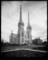 St. Francis Catholic Cathedral, from intersection of E. 12th and Pine, Portland. Power lines and street in foreground.