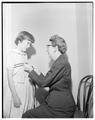 Mrs. Ida Ingalls measuring a young girl as research for her project on size standardization of children's clothing, April 1956