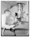 Dean Francois Gilfillan supervises electron microscope, 1956