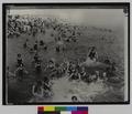 Crowds at beach in water (recto)