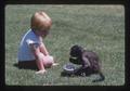 Child and spider monkey in park, Bend, Oregon, 1974