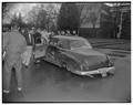 Students examining a car with no wheels, Memorial Union Quad, 1954