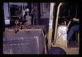 Loading pallet boxes with potatoes from conveyor belt, Metolius, Oregon, February 1972