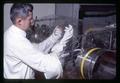 Frank Adams with hamster in plastic tent, Oregon State University, Corvallis, Oregon, February 1969