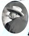 Portraits of a man in a suit and hat with cigar in mouth