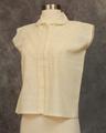 Blouse of unbleached cotton with bands of drawn work from shoulders to center of torso creating a triangle